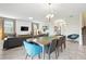 Open-concept living room with large television, a comfortable sofa, and marble tile flooring at 369 Ocean Course Ave, Davenport, FL 33896