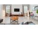 Inviting living room with stylish decor, featuring tile floors, modern furniture, and a textured accent wall at 369 Ocean Course Ave, Davenport, FL 33896