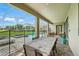 Covered patio with a dining table and pool area, creating an inviting space for entertaining at 369 Ocean Course Ave, Davenport, FL 33896