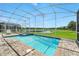 Sparkling screened-in pool and lake views, for recreation and relaxation at 369 Ocean Course Ave, Davenport, FL 33896
