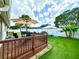 Wooden deck in a fenced backyard with outdoor seating and a manicured lawn at 3708 Beaver Ridge Dr, Orlando, FL 32829