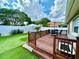 Elevated wooden deck in a fenced backyard with outdoor seating and manicured artificial lawn at 3708 Beaver Ridge Dr, Orlando, FL 32829