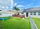 Well maintained backyard featuring a deck, artificial grass, and solar panels for energy efficiency at 3708 Beaver Ridge Dr, Orlando, FL 32829