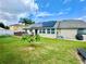 Spacious backyard featuring solar panels and a well-maintained lawn at 3708 Beaver Ridge Dr, Orlando, FL 32829