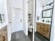 Bright bathroom featuring modern vanity, wood-look tile flooring, and a door to the outside at 3708 Beaver Ridge Dr, Orlando, FL 32829