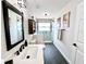 Bright bathroom featuring a modern vanity, dark wood floor, and a glass-enclosed shower at 3708 Beaver Ridge Dr, Orlando, FL 32829