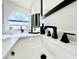 Close-up of a bathroom sink with modern black faucet and a frosted window in the background at 3708 Beaver Ridge Dr, Orlando, FL 32829