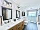 Modern bathroom with double sinks, white countertops, and a glass-enclosed shower at 3708 Beaver Ridge Dr, Orlando, FL 32829