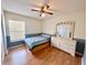 Comfortable bedroom with a ceiling fan, a large dresser, and a window at 3708 Beaver Ridge Dr, Orlando, FL 32829