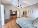 Bedroom features vaulted ceilings, wooden floors, and a large TV cabinet in neutral colors at 3708 Beaver Ridge Dr, Orlando, FL 32829