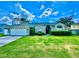 Landscaped front yard and exterior of the home featuring a two-car garage and light-grey paint at 3708 Beaver Ridge Dr, Orlando, FL 32829