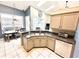 Bright kitchen featuring granite countertops, a stainless steel sink, and ample cabinet space at 3708 Beaver Ridge Dr, Orlando, FL 32829