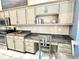 Kitchen featuring granite countertops, stainless appliances, a built-in desk, and painted cabinets at 3708 Beaver Ridge Dr, Orlando, FL 32829