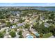 Aerial view emphasizing the property's proximity to the lake and other homes surrounded by mature trees at 3722 Neptune Dr, Orlando, FL 32804