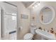 Clean bathroom featuring pedestal sink, decorative mirror and framed artwork at 3722 Neptune Dr, Orlando, FL 32804