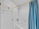 Bathroom featuring a shower/tub combination with a blue shower curtain and white tiled walls at 3722 Neptune Dr, Orlando, FL 32804