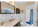 Well-lit bathroom with a vanity, toilet, and a shower/tub combination with a blue shower curtain at 3722 Neptune Dr, Orlando, FL 32804
