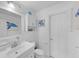 Bright, all-white bathroom with a large vanity and sea-themed decor at 3722 Neptune Dr, Orlando, FL 32804