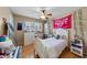Cozy bedroom featuring hardwood floors, a ceiling fan, and ample natural light from the window at 3722 Neptune Dr, Orlando, FL 32804
