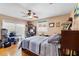 Bedroom with hardwood floors, a ceiling fan, and access to a sliding glass door for outdoor enjoyment at 3722 Neptune Dr, Orlando, FL 32804