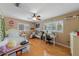 Bright bedroom with hardwood floors, a ceiling fan, and large windows providing plenty of sunlight at 3722 Neptune Dr, Orlando, FL 32804