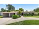 Charming single-story home with manicured landscaping, a carport, and a welcoming front entrance at 3722 Neptune Dr, Orlando, FL 32804