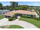 Charming single-story home with a well-manicured lawn, inviting walkway, mature trees, and a circular driveway at 3722 Neptune Dr, Orlando, FL 32804