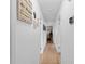Well-lit hallway with hardwood floors and decoratively adorned walls at 3722 Neptune Dr, Orlando, FL 32804