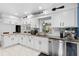 Bright kitchen with white cabinets, stainless steel appliances, and stylish decor at 3722 Neptune Dr, Orlando, FL 32804