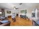 Open living space with hardwood floors, a ceiling fan, and seamless flow into the adjacent dining and kitchen areas at 3722 Neptune Dr, Orlando, FL 32804