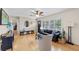 Bright living room with hardwood floors, ceiling fan, and large windows offering natural light and backyard views at 3722 Neptune Dr, Orlando, FL 32804