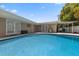 Tranquil pool surrounded by brick pavers and mature trees, creating a peaceful and private backyard retreat at 3722 Neptune Dr, Orlando, FL 32804