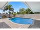 Inviting pool surrounded by brick pavers and lush tropical landscaping, creating a private backyard oasis at 3722 Neptune Dr, Orlando, FL 32804