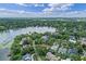 Picturesque aerial shot showcases waterfront properties with sprawling lawns and serene lake access at 446 Alberta Dr, Winter Park, FL 32789