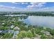 Stunning aerial view of a waterfront community with lush green landscape and beautiful lake views at 446 Alberta Dr, Winter Park, FL 32789