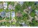 Aerial view of home with mature trees and manicured lawns in a serene neighborhood at 446 Alberta Dr, Winter Park, FL 32789