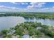 Gorgeous aerial view of a lakeside home surrounded by lush greenery and beautiful waterfront scenery at 446 Alberta Dr, Winter Park, FL 32789