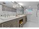 Bathroom with double sinks, a large mirror, and a tiled shower at 446 Alberta Dr, Winter Park, FL 32789