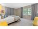 Bedroom with large window, curtains, carpet, and a floral bedspread at 446 Alberta Dr, Winter Park, FL 32789