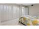 Bright bedroom featuring a closet with bi-fold doors and neutral carpet at 446 Alberta Dr, Winter Park, FL 32789