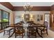 Traditional dining room featuring a wood table, chandelier, and large window providing natural light at 446 Alberta Dr, Winter Park, FL 32789