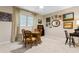 Cozy dining room featuring a wooden table with seating for four, light-filled from a window, and carpeted floors at 446 Alberta Dr, Winter Park, FL 32789