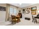 Well-lit dining area with wooden table, seating, and decorative wall art at 446 Alberta Dr, Winter Park, FL 32789