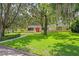 Beautiful single-story home with a lush green lawn, mature trees, and nice curb appeal at 446 Alberta Dr, Winter Park, FL 32789
