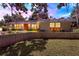 Charming brick home with a well-maintained front yard, colorful evening skies, and a beautiful landscape at 446 Alberta Dr, Winter Park, FL 32789