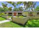Inviting single-story home with manicured lawn, brick walkway, and lush trees at 446 Alberta Dr, Winter Park, FL 32789