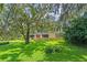 Lush front yard with mature trees with Spanish moss adding charm to this home at 446 Alberta Dr, Winter Park, FL 32789
