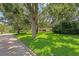 Beautiful home with lush, green lawn and mature trees draped with Spanish moss at 446 Alberta Dr, Winter Park, FL 32789