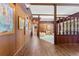 Spacious hallway with wood paneling, hardwood floors, and art at 446 Alberta Dr, Winter Park, FL 32789