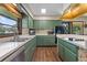 Bright kitchen with green cabinets and white countertops at 446 Alberta Dr, Winter Park, FL 32789